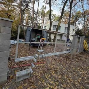 Metal gate frame prepared for WPC fluted cladding infill before final panel installation.