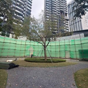 Wide view of the sunken commercial courtyard wall area prepared for co-extrusion fluted cladding installation.