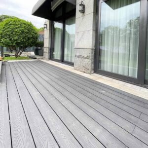black composite decking 3d wood grain boards installed along villa facade patio