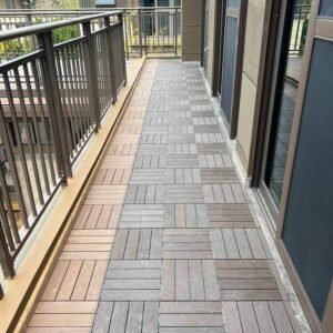 dual tone interlocking deck tiles teak grey installed on narrow outdoor corridor with railing and doors