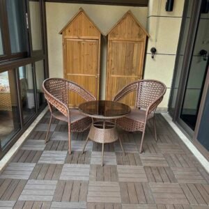 teak and grey interlocking wpc deck tiles on villa balcony seating area with rattan chairs